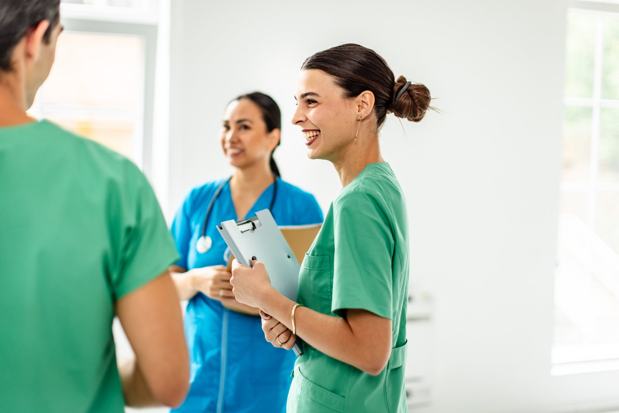 Clinical team collaborating in hospital corridor